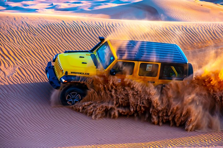 Experience the magic of Dubai’s Al Lahab Red Dune as you navigate stunning sandy trails in a Jeep Wrangler creating unforgettable memories with every twist and turn.
